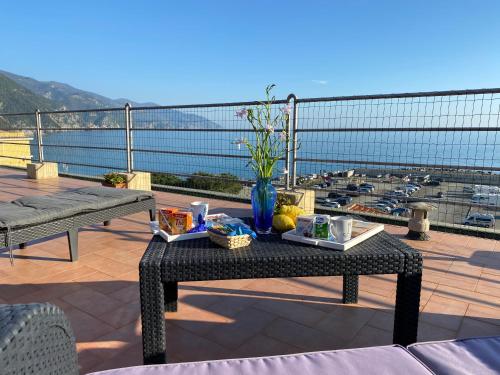 a table on a balcony with a view of a harbor at La Casa sul Mare - Monterosso - Cinque Terre in Monterosso al Mare