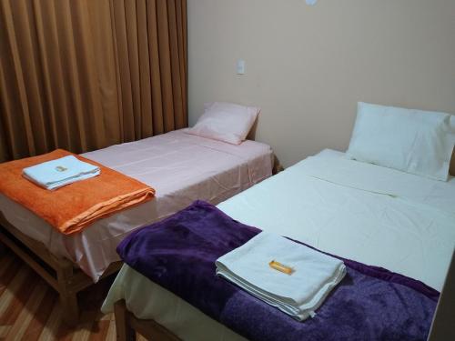 two beds sitting next to each other in a room at D' Barrig in Trujillo