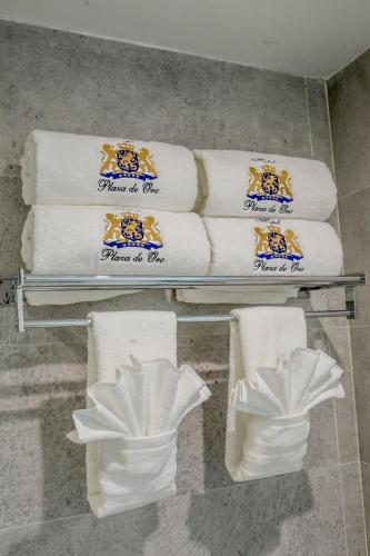 a bunch of towels on a shelf in a bathroom at Plaza de Oro in Monterrey