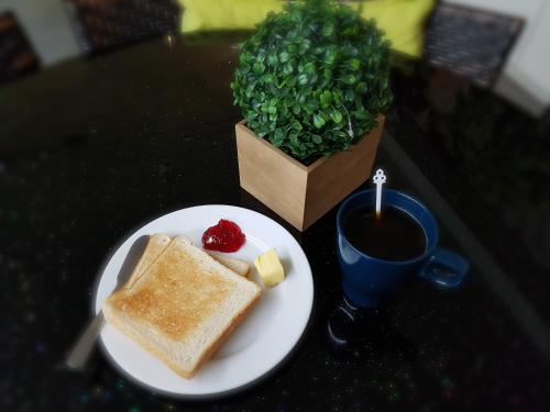 a table with a plate of toast and a cup of coffee at V Garden Hotel in Kuala Lumpur