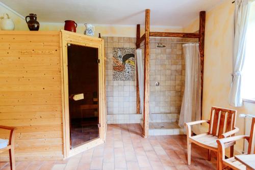 a bathroom with a shower with a glass door at Stará Škola in Košariská-Priepasné