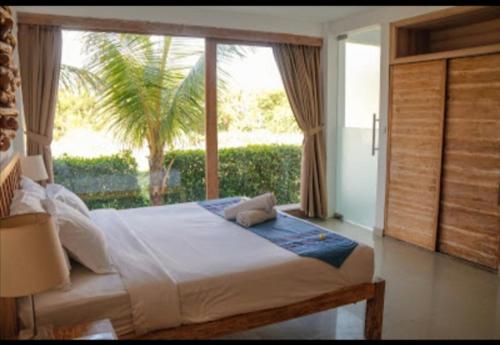 A bed or beds in a room at D'sawah Villa