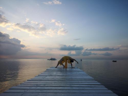 a person standing on a dock in the water at Sugarsea Inn & Dive shop in Mactan