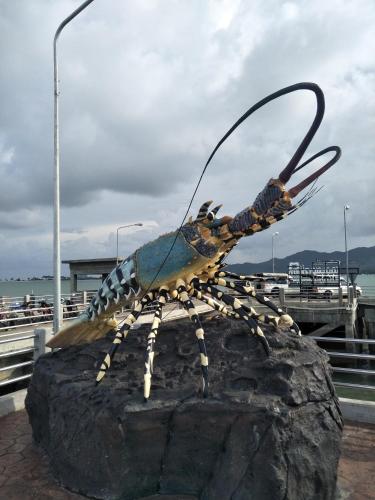 a statue of a bug on a rock at Baan Kebsap บ้านเก็บทรัพย์ in Ko Yao Noi