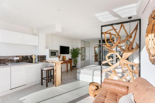 - une cuisine et un salon avec un lit en arrière-plan dans l'établissement Bali Heliopolis naturiste, au Cap d'Agde