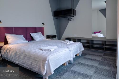 Кровать или кровати в номере Dandelion Apartments Matīsa