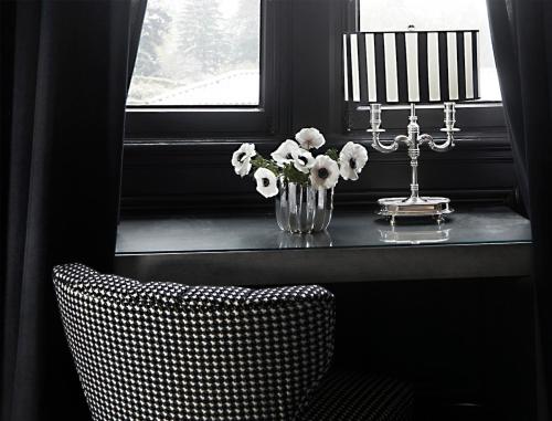 a table with a vase of flowers and a chair at Maison D'Anthouard in Écully