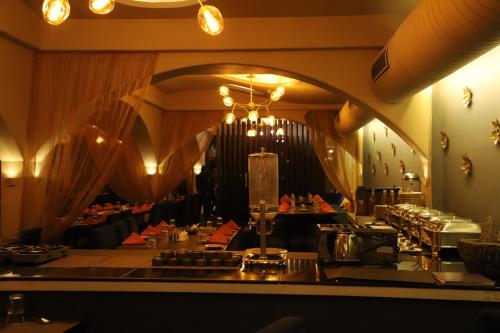 a dining room with tables and a chandelier at The Purple Leaf Hotels in Hyderabad