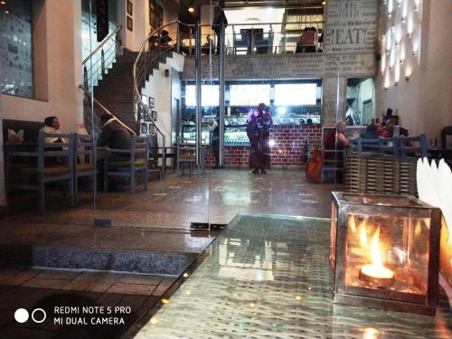 a restaurant with a fireplace in the middle of a room at Maya Heritage in Bodh Gaya