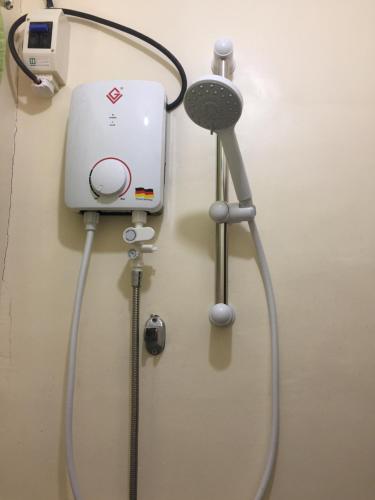 a hair dryer and a blow dryer on a wall at JaiJai's Backpackers in Coron