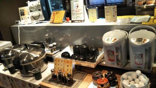 a kitchen with a counter with some food on it at Gran Customa Isezakicho in Yokohama