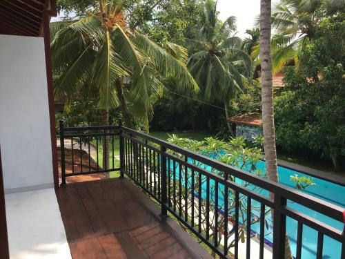 a balcony with a view of the pool at Villa 45 - Balapitiya in Balapitiya