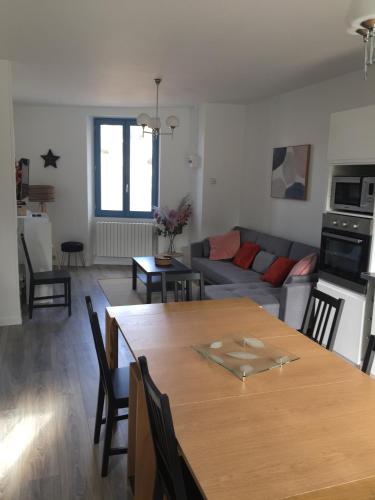 un salon avec une table et un canapé dans l'établissement Gîte du rocher, au Puy-en-Velay