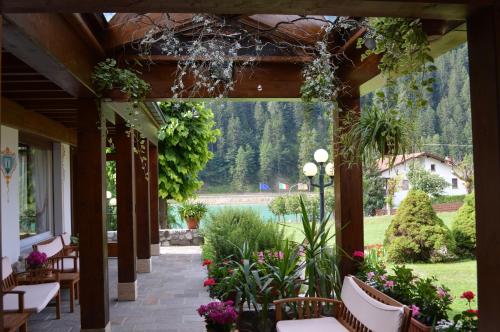 a patio with a bunch of plants and flowers at Hotel Panoramic in Auronzo di Cadore