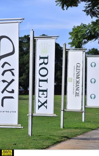 a group of signs sitting on the grass at Royal Suite Caesarea in Caesarea