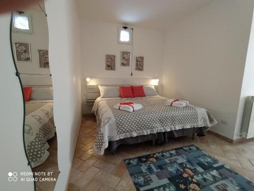 a bedroom with a bed with red pillows on it at La Casa di Alberto in Camerino
