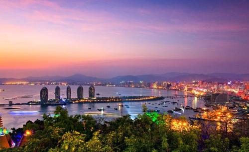 a view of a city with a river at night at Care Hotel Coast Collection in Sanya