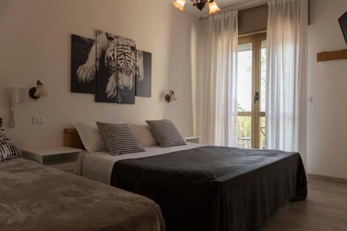 a bedroom with two beds and a window at Infinity in Cervia