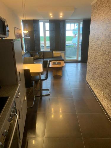 a living room with a couch and a table at Ferienwohnung 210 Vitamar in Schmarren