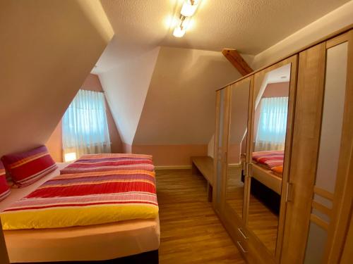 a bedroom with a bed in a room with a staircase at Ferienwohnungen Conny in Rudolstadt