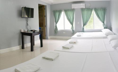A bed or beds in a room at Sandscape Hotel