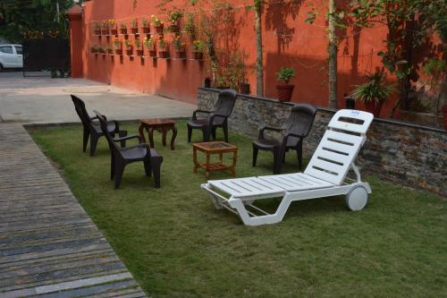 a group of chairs and lounge chairs on the grass at JJK @ STAY HOME in Dehradun