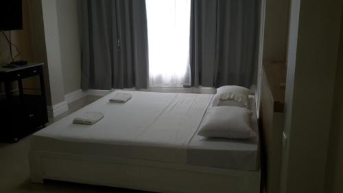 Ein Bett oder Betten in einem Zimmer der Unterkunft Sandscape Hotel
