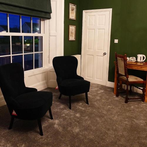 a room with two chairs and a table and a window at The Bell at Old Sodbury in Chipping Sodbury
