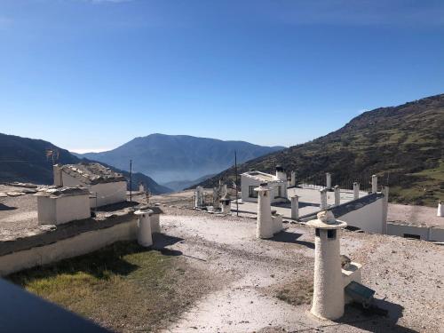 a view of a cemetery with mountains in the background at Hotel Rural Real de Poqueira in Capileira