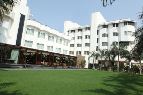 a large building with a lawn in front of it at Hotel Express Residency Vadodara in Vadodara