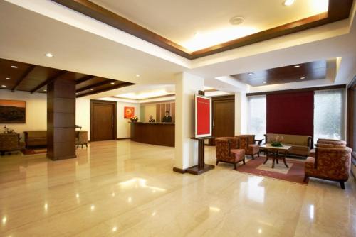 a lobby of a hotel with chairs and a table at Hotel Express Residency Vadodara in Vadodara