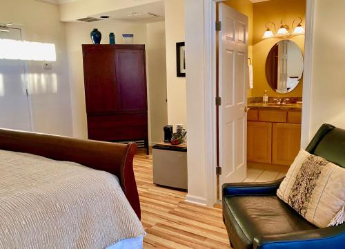 a bedroom with a bed and a bathroom with a sink at Inn on Main Hotel in Manasquan