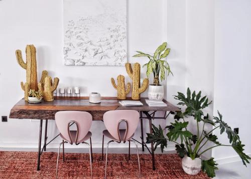 une table à manger avec des chaises roses et un cactus dans l'établissement Mana EcoRetreat, à Las Breñas