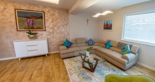 a living room with a couch and a table at Villa VAND Paradiso in Međugorje
