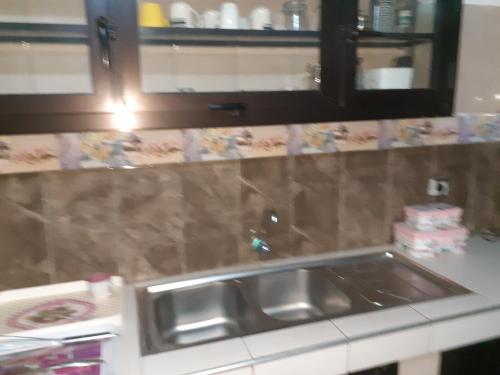 a kitchen with a sink and a counter top at Belle Villa Nassima in Thiès