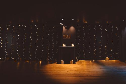 a lit up room with a vase and candles at HOY Paris - Yoga Hotel in Paris