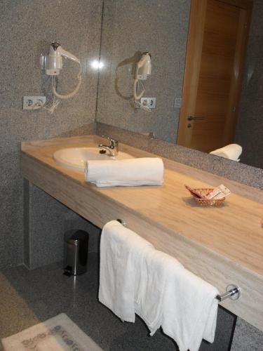 a bathroom with a sink and a mirror at Hotel Palacio de Asturias in Oviedo