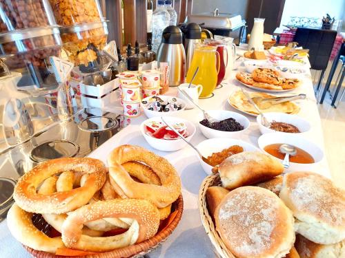 a table topped with pretzels and other dishes of food at Hotel Palladium Sithonia in Kalamitsi