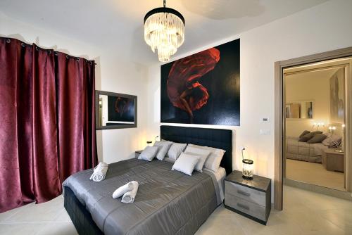 a bedroom with a large bed with red curtains at Casa Calari 2 in Casa Calari