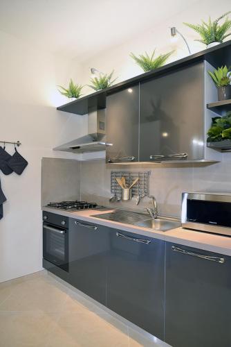 a kitchen with a sink and a stove at Casa Calari 2 in Casa Calari