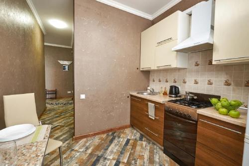 a kitchen with white cabinets and a counter top at PaulMarie Apartments on Mira 25B in Mogilev