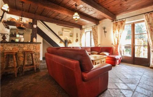 Elle comprend un salon doté d'un mobilier en cuir rouge et d'une cheminée. dans l'établissement Awesome Home In La Roquette Sur Siagne, à La Roquette-sur-Siagne