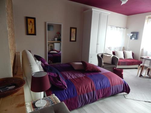 a bedroom with a bed with a purple blanket at Le Rosette Assisi in Cannara