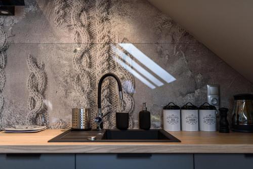 a kitchen with a sink and a counter top at Apartamenty Pulower z klimatyzacją - Dream Apart in Szczyrk