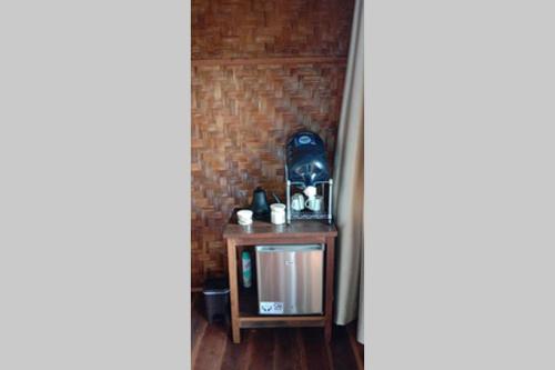 a table in a room with a brick wall at SeaGate Bungalows in Sabong