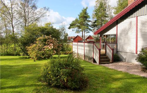 a house with a red roof and a yard at Amazing Home In Öxabäck in Öxabäck