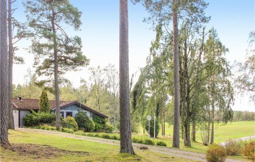 a house in the woods with trees at Amazing Home In Öxabäck in Öxabäck
