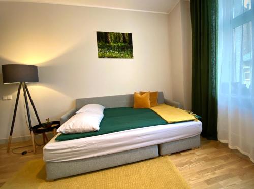 a small bed in a room with a window at Riga A new designed cosy family apartment in Riga