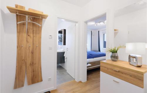a room with a bathroom with a bed and a wooden door at 1 Bedroom Nice Apartment In Rechlin in Rechlin