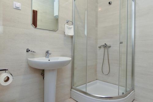 a bathroom with a sink and a shower at BARBETA Accommodation in Budva